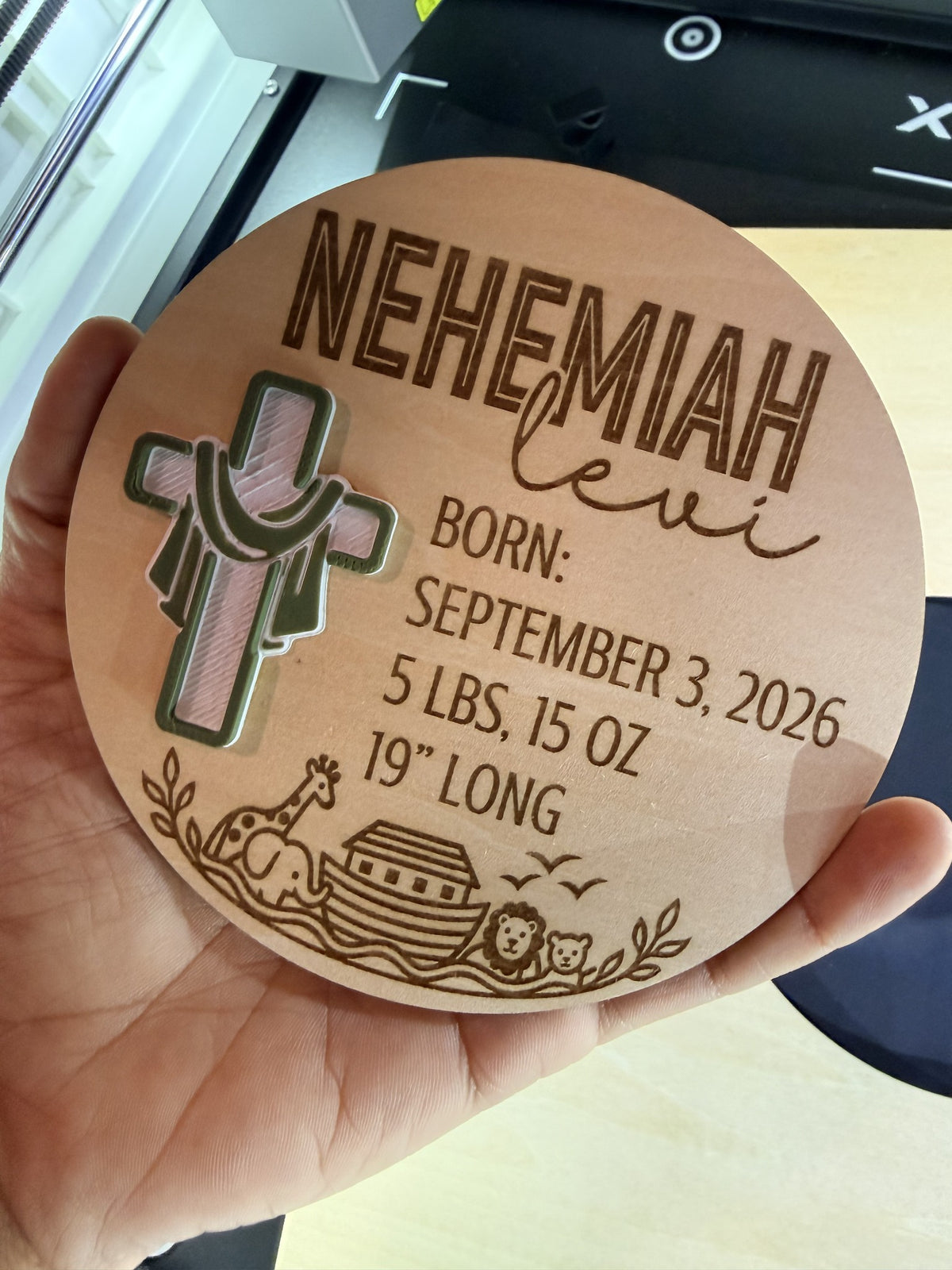 Personalized round wooden newborn birth stats sign with Noah’s Ark engraving and layered cross